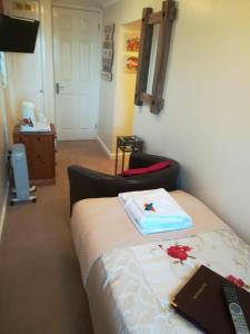 um quarto com uma cama com um controlo remoto em Thurlestone House em St. Ives