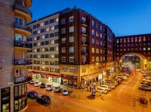 a city street with cars parked in front of buildings at Roombach Hotel Budapest Center in Budapest