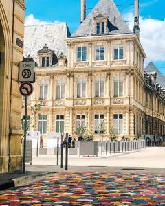 a large building with a rug in front of it at Loft Royal des Promenades in Reims