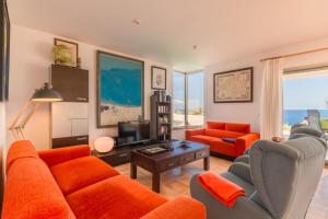 a living room with a couch and chairs and a tv at Cala Murada - 2778-83 Mallorca in Cala Murada