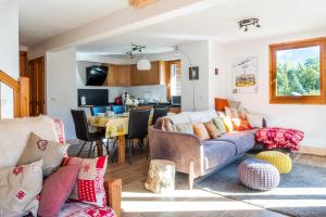a living room with a couch and a table at Glacier - Les Amethystes in Les Trabets +9 photos