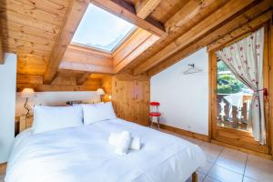 a bedroom with a large white bed with a window at Glacier - Les Amethystes in Les Trabets