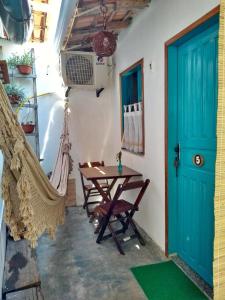 a room with a hammock and a table and a door at Estação Caraíva in Caraíva +41 photos