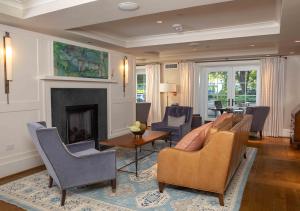 a living room with chairs and a fireplace at Boar's Head Resort in Charlottesville