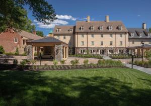 a large building with a lawn in front of it at Boar's Head Resort in Charlottesville