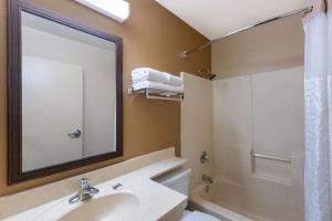 a bathroom with a sink and a shower and a mirror at Extended Stay America Suites - Chicago - Woodfield Mall in Schaumburg