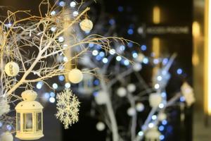 a christmas tree with lights and a lantern at Royal Tulip City Center in Tangier