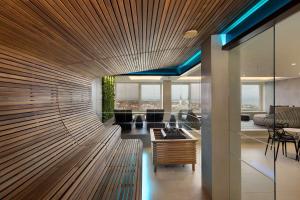a lobby with a large wooden wall with blue lights at Radisson Blu Hotel Olümpia in Tallinn