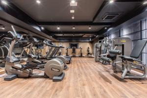 a gym with several treadmills and cardio machines at Radisson Blu Hotel Prague in Prague