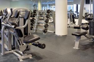 a gym with a bunch of weights and machines at Park Inn by Radisson Meriton Conference & Spa Hotel Tallinn in Tallinn