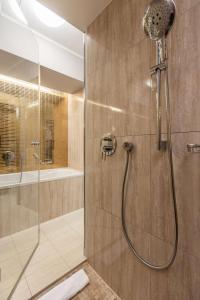 a bathroom with a shower with a glass door at Radisson Blu Hotel Prague in Prague