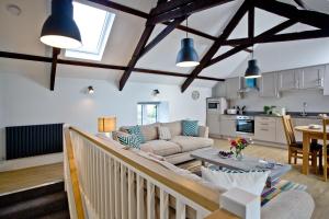 a living room with a couch and a table at The Barn, 21 At The Beach, Torcross in Beesands