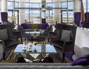 a living room with couches and a table at Radisson Blu Waterfront Hotel, Jersey in Saint Helier Jersey