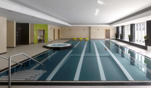 
a room with a pool, chairs, and tables in it at Radisson Blu Hotel, Durham in Durham

