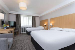 a hotel room with two beds and a television at Park Inn by Radisson Shannon Airport in Shannon