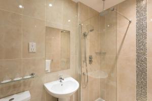 a bathroom with a shower and a sink and a toilet at Park Inn by Radisson Shannon Airport in Shannon