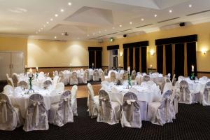 a room filled with tables with white table cloth at Park Inn by Radisson Shannon Airport in Shannon