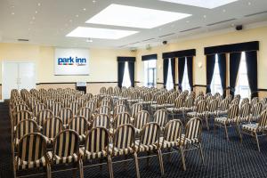a room with rows of chairs in front of a screen at Park Inn by Radisson Shannon Airport in Shannon