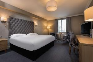 a hotel room with a large bed and a television at Park Inn by Radisson Shannon Airport in Shannon