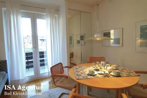 a dining room with a table and chairs and a window at PERLE - Ski-to-door Family apartment in Bad Kleinkirchheim