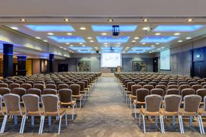 a room with rows of chairs and a projection screen at Radisson Blu Hotel, Athlone in Athlone