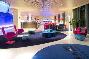 a lobby with colorful chairs and a waiting area at Radisson Blu Hotel, Lucerne in Luzern