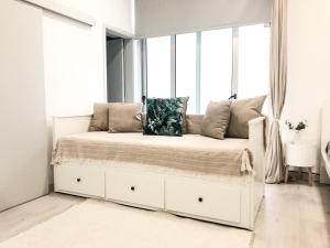 a white bed in a room with a window at Sea, Sand and Sun Spot - Espinho Beach in Espinho