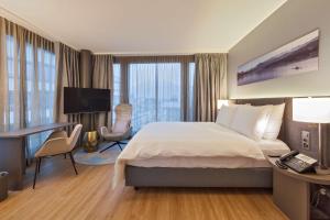 a hotel room with a bed and a desk and a computer at Radisson Blu Hotel, Lucerne in Lucerne