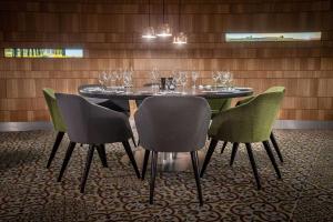 a dining room with a table with wine glasses on it at Radisson Blu Hotel, Hamburg Airport in Hamburg