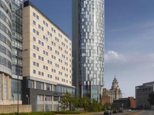 two tall buildings in a city with a street at Radisson Blu Hotel, Liverpool in Liverpool