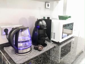 a coffee maker on a counter next to a microwave at Sea, Sand and Sun Spot - Espinho Beach in Espinho