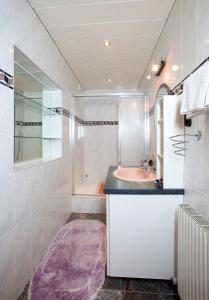 Baño blanco con lavabo y espejo en Familienferienhaus Florentine, en Längenfeld