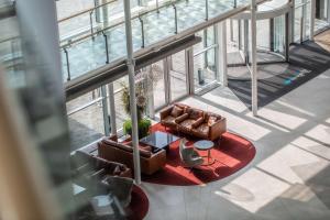 an overhead view of a living room with two chairs and a table at Radisson Blu Hotel London Stansted Airport in Stansted Mountfitchet
