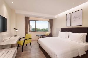 Postel nebo postele na pokoji v ubytování AIHO Hotel Medan