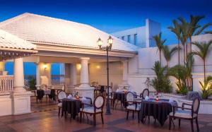 a restaurant with tables and chairs in front of a building at Radisson Blu Kochi in Cochin