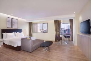 Postel nebo postele na pokoji v ubytování AIHO Hotel Medan
