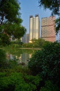 a city skyline with tall buildings and a pond at Radisson Blu Hotel Liuzhou in Liuzhou
