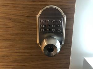 a lock on a door on a wooden floor at The Duplex with Air Conditioning & Private Deck Area in Margate