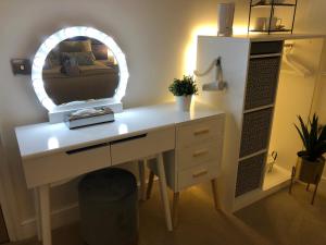 a desk with a mirror on top of it at The Duplex with Air Conditioning & Private Deck Area in Margate