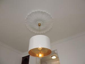 a large white chandelier hanging from a ceiling at Casita de Santos in Málaga