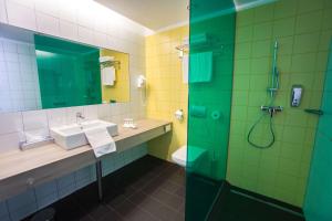 a bathroom with a sink and a shower at Park Inn By Radisson Budapest in Budapest