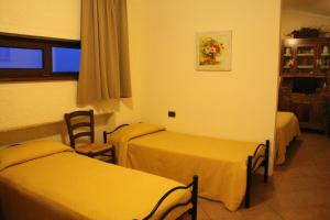 a hotel room with two beds and a window at Angelucci Agriturismo con Camere e Agri Camping in Lanciano