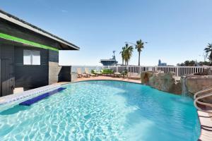 a swimming pool with a large swimming pool in it at DoubleTree by Hilton Corpus Christi Beachfront in Corpus Christi