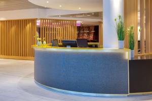 a lobby with a blue counter in a building at Radisson Blu Hotel Oslo Alna in Oslo
