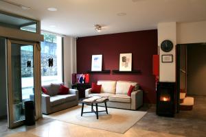 a living room with a couch and a table at Hotel Cangas de Onis Center in Cangas de Onís