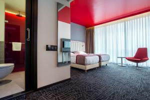 a hotel room with a bed and a bathroom at Park Inn By Radisson Istanbul Ataturk Airport in Istanbul