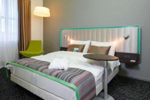 a hotel room with a bed and a table at Park Inn by Radisson Novokuznetsk in Novokuznetsk