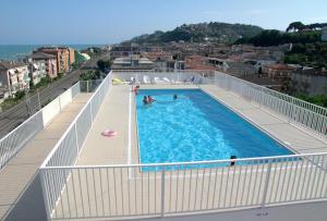 a large swimming pool on top of a building at Residence I Delfini in Cupra Marittima