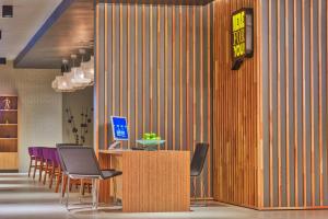 a lobby with a table with chairs and a sign at Park Inn by Radisson Novokuznetsk in Novokuznetsk