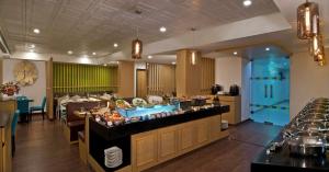 a restaurant with a buffet in the middle of a room at Park Inn By Radisson Amritsar Airport in Amritsar